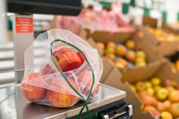Close-up of ecologically friendly reusable bag with apples