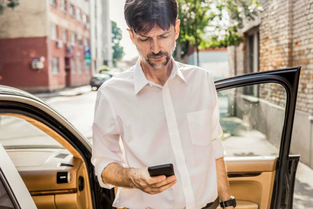 istock handsome businessman using his smartphone 1159377056