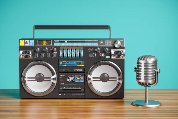 istock Cassette tape recorder and vintage microphone on wooden table 1159377137