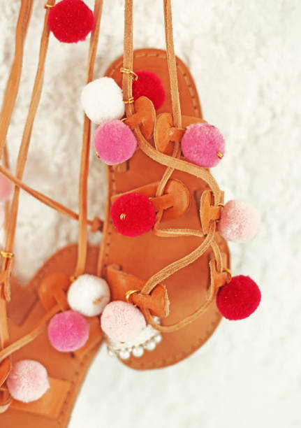 greek leather sandals for girls with colorful pom pom - gladiator sandals greek leather sandals for girls with colorful pom pom - gladiator sandals - kids shoes advertisement gladiator shoe stock pictures, royalty-free photos & images