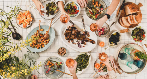 istock Peoples hands with glasses of wine over table with snacks 1159377799