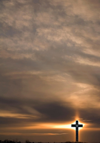 Crucifix and evening sunlight with ice crystals