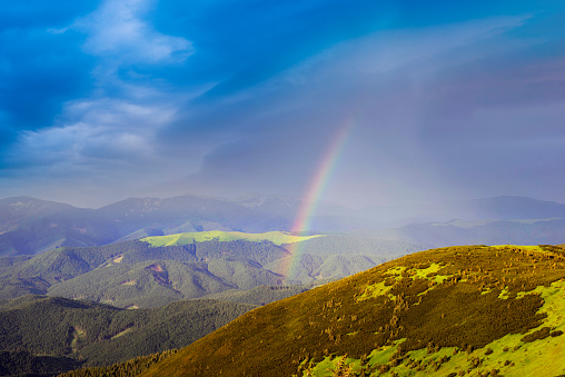 Rainbow in the Ukrainian Carpathians after a severe thunderstorm with lightning and thunder over the ski resort in the village of Polyanitsa, under the mountain Synyak in Gorgany.