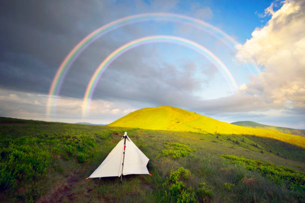 The lonely homemade white tent of a traveler who values ultralight mining equipment. White color to reflect the rays of the sun in the heat