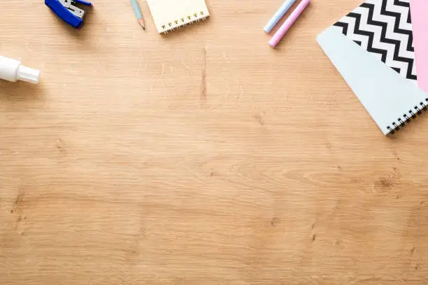 Photo of School supplies on wooden desk table background. Back to school concept. Flat lay, top view.