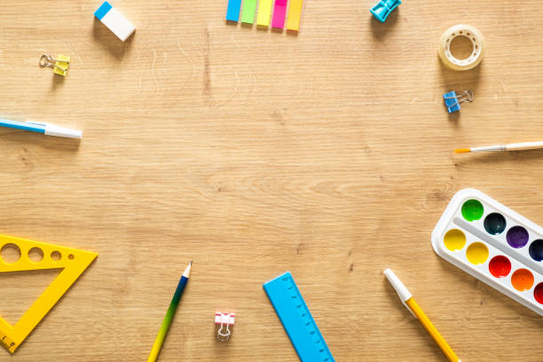 istock School stationery frame on wooden background. Back to school concept. Flat lay style composition, top view, overhead. 1159380459