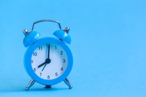 istock Blue alarm clock on blue background. Minimalism. 1159381512