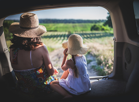 Mother and little daughter travel by car