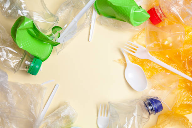 istock Recycling concept. ecology, environmental pollution. Background of crushed and crumpled plastic. Top view copy space. Yellow background horizontal. ready Ban plastic. plastic pollution 1159381629