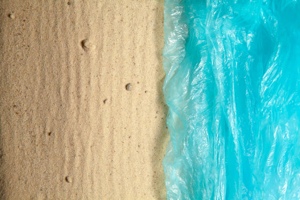 istock Creative artwork concept of plastic pollution. Sea from plastic bag goes to sand beach. Top view, copy space. Ban plastic. ecology, environmental, plastic pollution. Ocean pollution. creative poster 1159381686