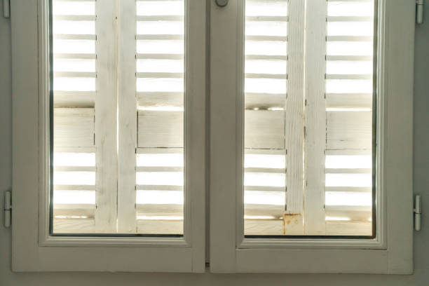 Bordeaux, France upstairs window in a residential street with shutters and windows closed .