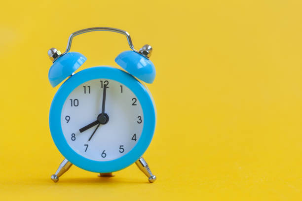 istock Blue alarm clock on yellow background. Minimalism. Contrast concept. 1159382113
