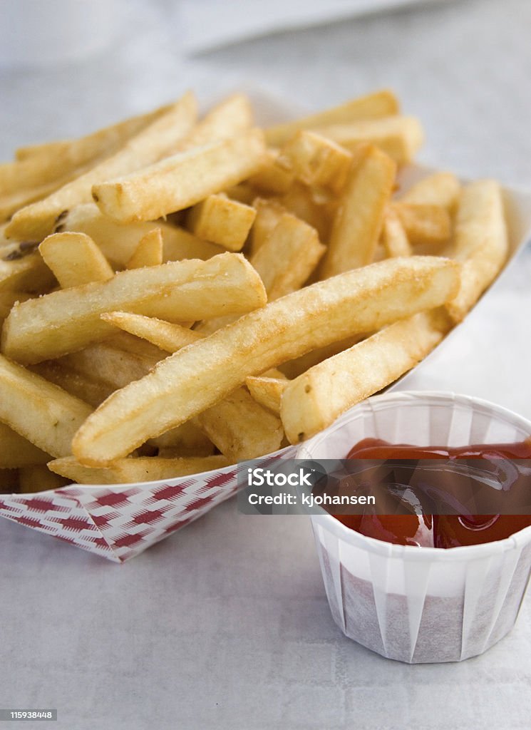 Culinary shot of a serving of fries with ketchup A basket of french fries with ketchup. Basket Stock Photo