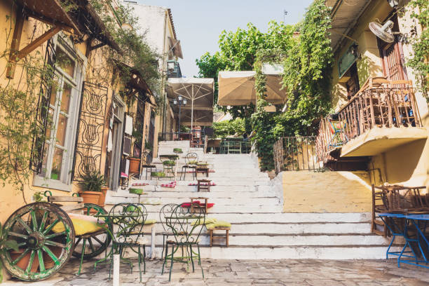 Athens old town, Greece Charming street with cafe tables, Plaka district, Athens, Greece plaka athens stock pictures, royalty-free photos & images