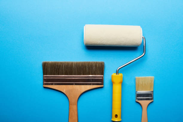 istock top view of roller and brushes on blue bright background with copy space 1159385570
