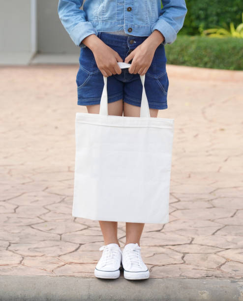 istock young model holding white tote bag for mockup blank template 1159385829