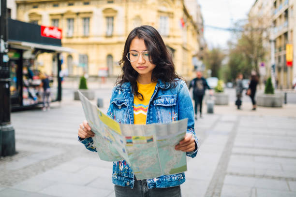 istock Chinese tourist woman holding map 1159385943