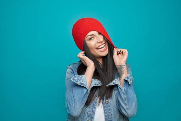istock Playful girl in red wool hat and denim jacket posing. 1159387257