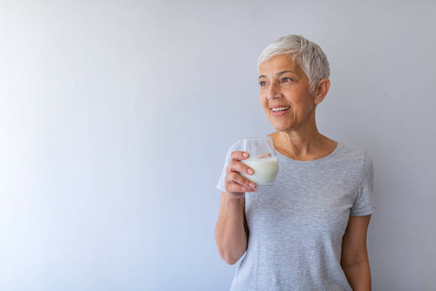 istock Senior woman drinking milk at home 1159387412