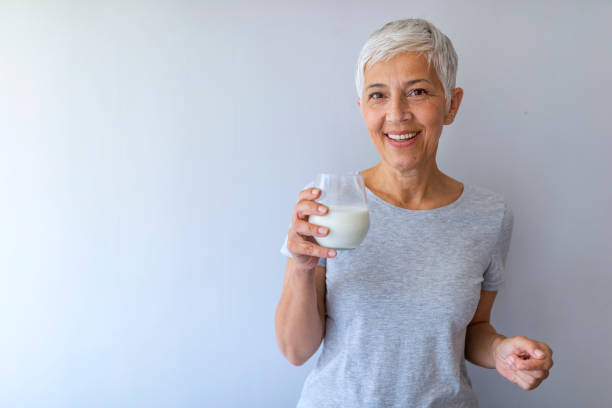 istock Senior woman drinking milk at home 1159387436
