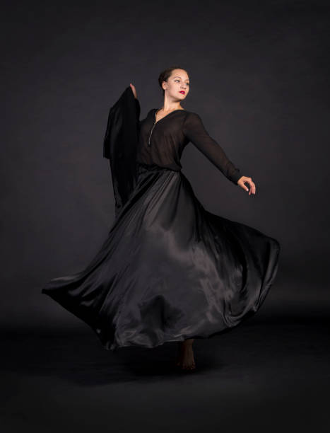 istock A young,smiling girl in black suit dancing modern choreography. 1159387748