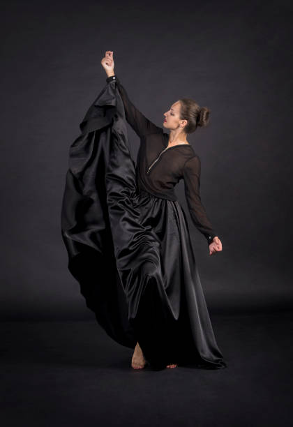 istock A young,smiling girl in black suit dancing modern choreography. 1159387859