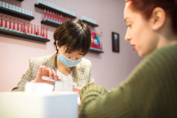 istock Chinese manicurist working at beauty salon 1159388557