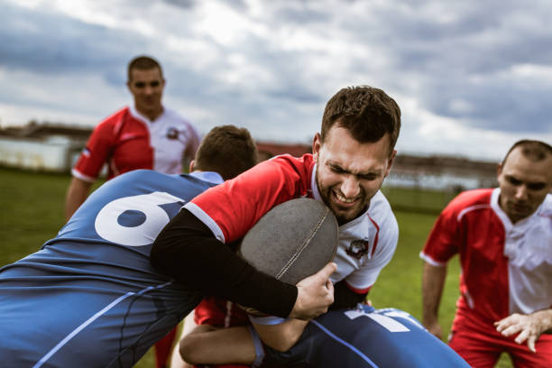 istock Rugby player making an effort while trying to pass rivals on a match. 1159388758