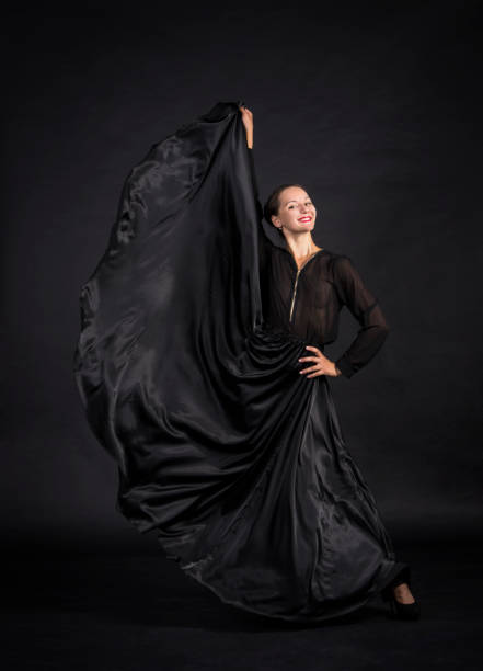 istock A young,smiling girl in black suit dancing modern choreography. 1159388846