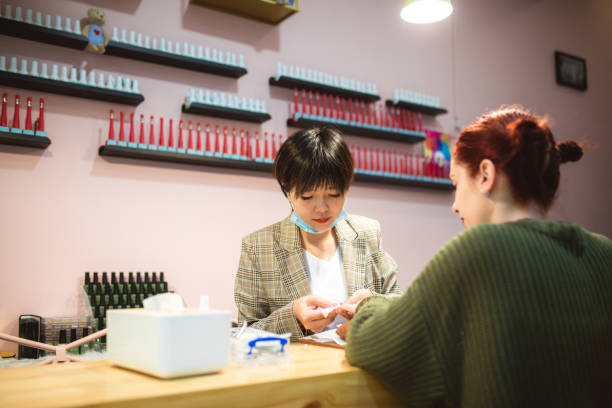 istock Chinese beautician doing a manicure treatment 1159389305