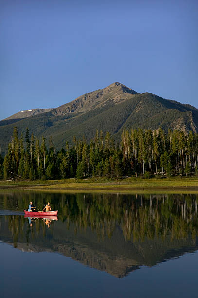 istock Couple Canoeing on Mountain Lake 115938987