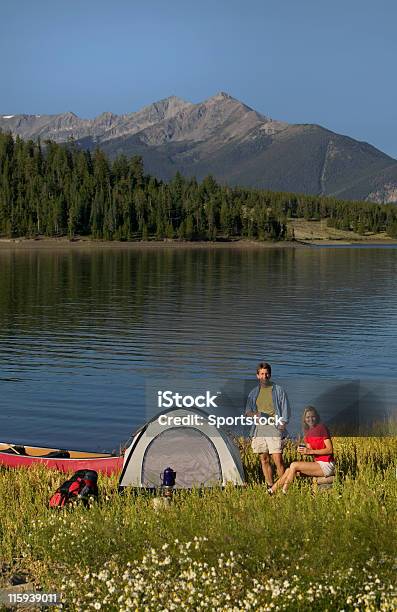 Couple Drinking Coffee At Mountain Lakeside Camp Site Stock Photo - Download Image Now