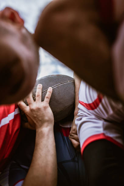 istock Close up of unrecognizable athletes during rugby match. 1159390112