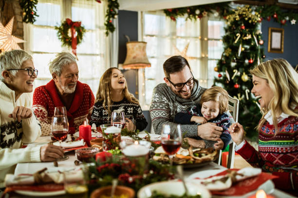 istock Happy multi-generation family having fun during New Year's lunch at dining table. 1159390345