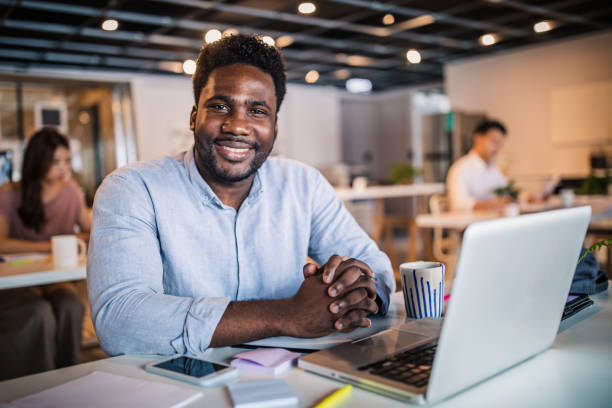 istock Charming black gentleman in modern office 1159390592