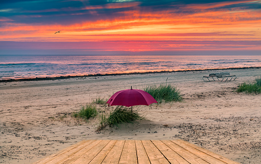 Colorful sunrise on sandy beach of the Baltic Sea in Jurmala
