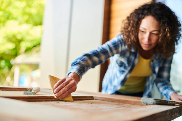 sanding an old door a woman sands a vintage wooden door sand paper stock pictures, royalty-free photos & images