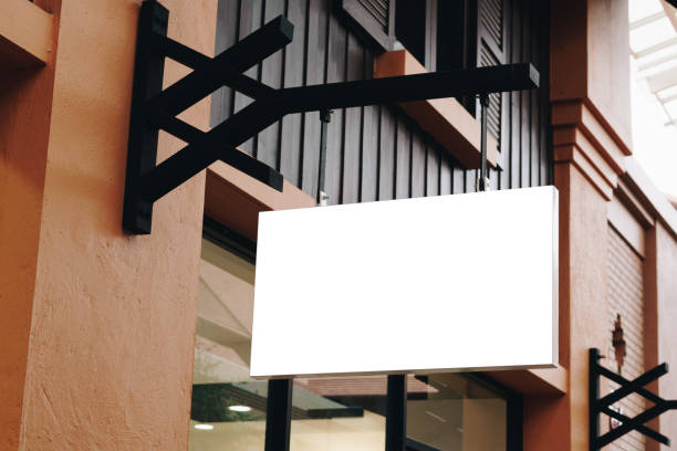 istock Empty signage and blank mock up hanging on street with copy space 1159391673