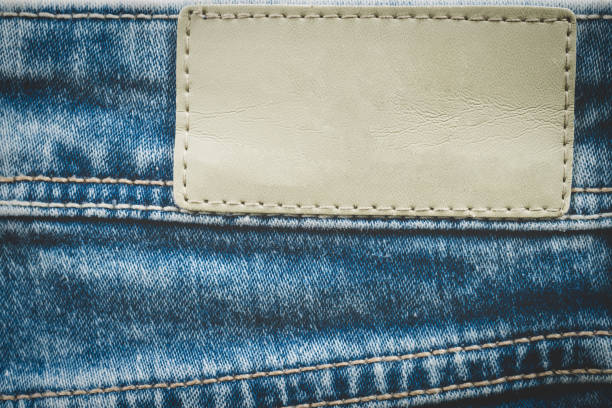 empty leather label on jeans background with copy space - leather patch denim jeans imagens e fotografias de stock