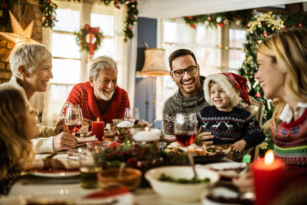 istock Happy extended family talking during New Year's meal at dining table. 1159391912