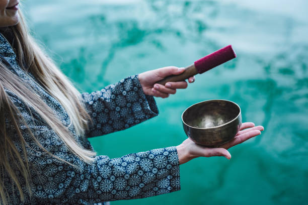 istock Young woman with Tibetan bowl 1159393565
