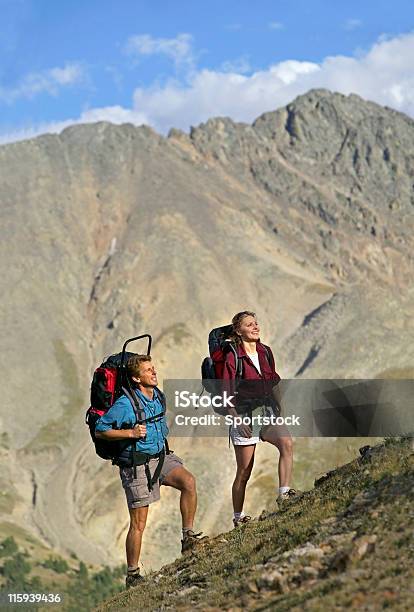 Couple Hiking In Rocky Mountains Stock Photo - Download Image Now - Colorado, Hiking, Mountain
