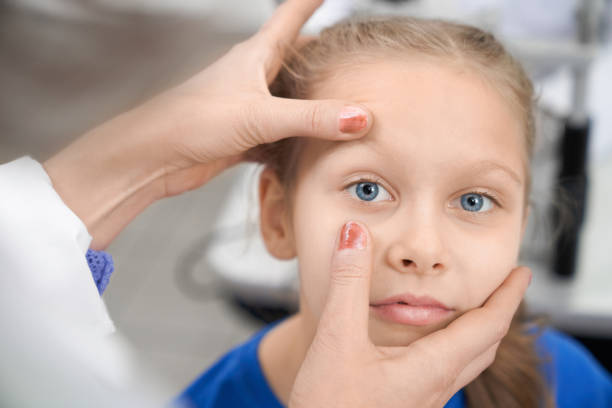 istock Pretty girl looking at camera while oculist checking vision 1159394648