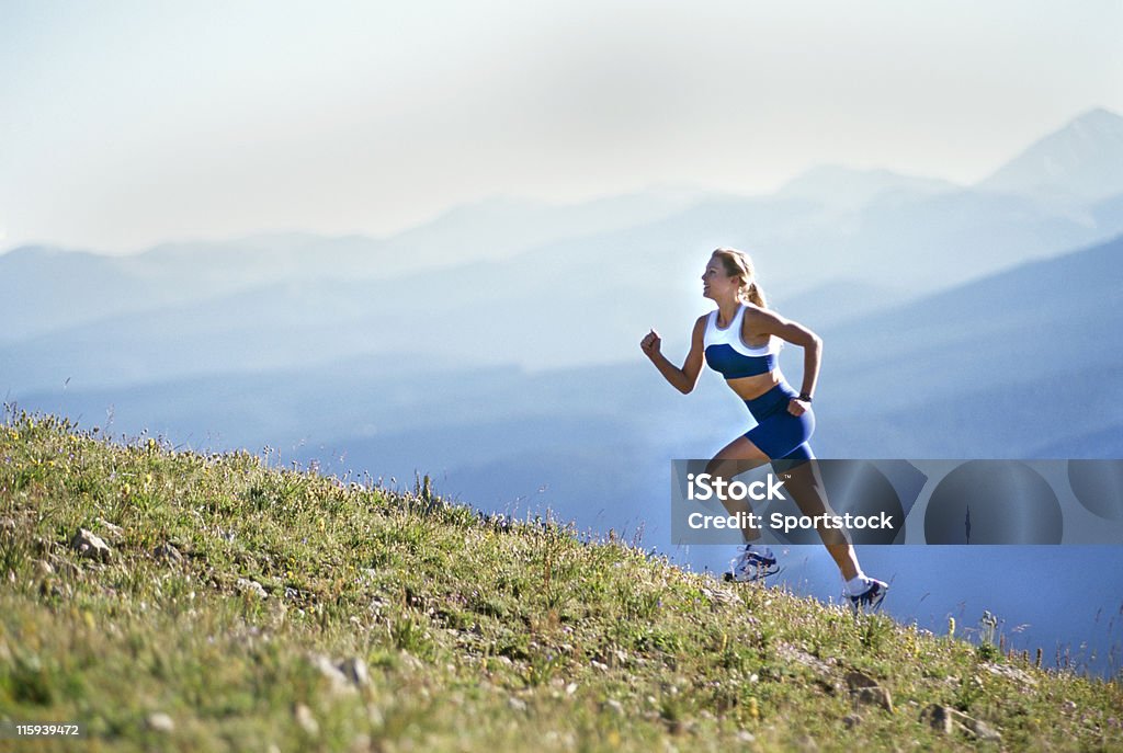 Beautiful Woman Running up Mountain Woman Running Up Hill with Mountain View Climbing Stock Photo