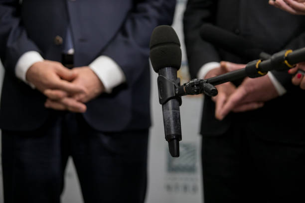 istock Media interview - group of journalists surrounding VIP 1159395591
