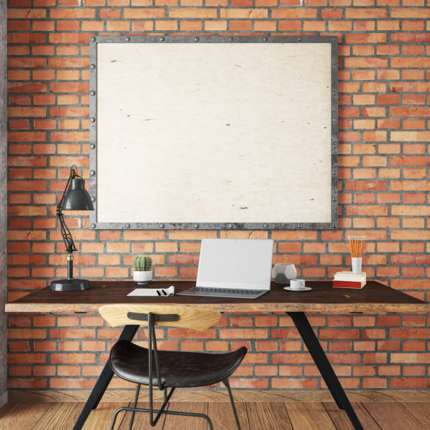 istock Laptop on a Wooden Desk with accessories and Empty Frame 1159395934