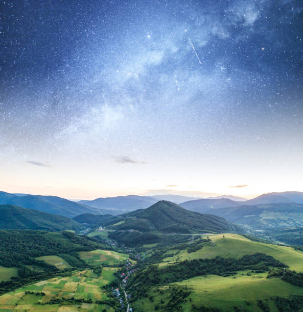 istock Starry sky against a mountain landscape. 1159397617