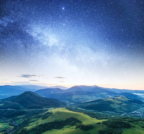 istock Starry sky against a mountain landscape. 1159397622