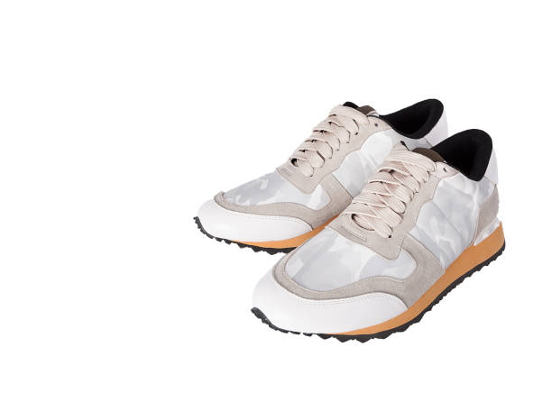 istock white stylish sneakers on a light background 1159398333