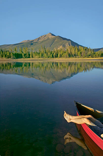 istock Bare Feet and Canoe with Beautiful Mountain 115939955